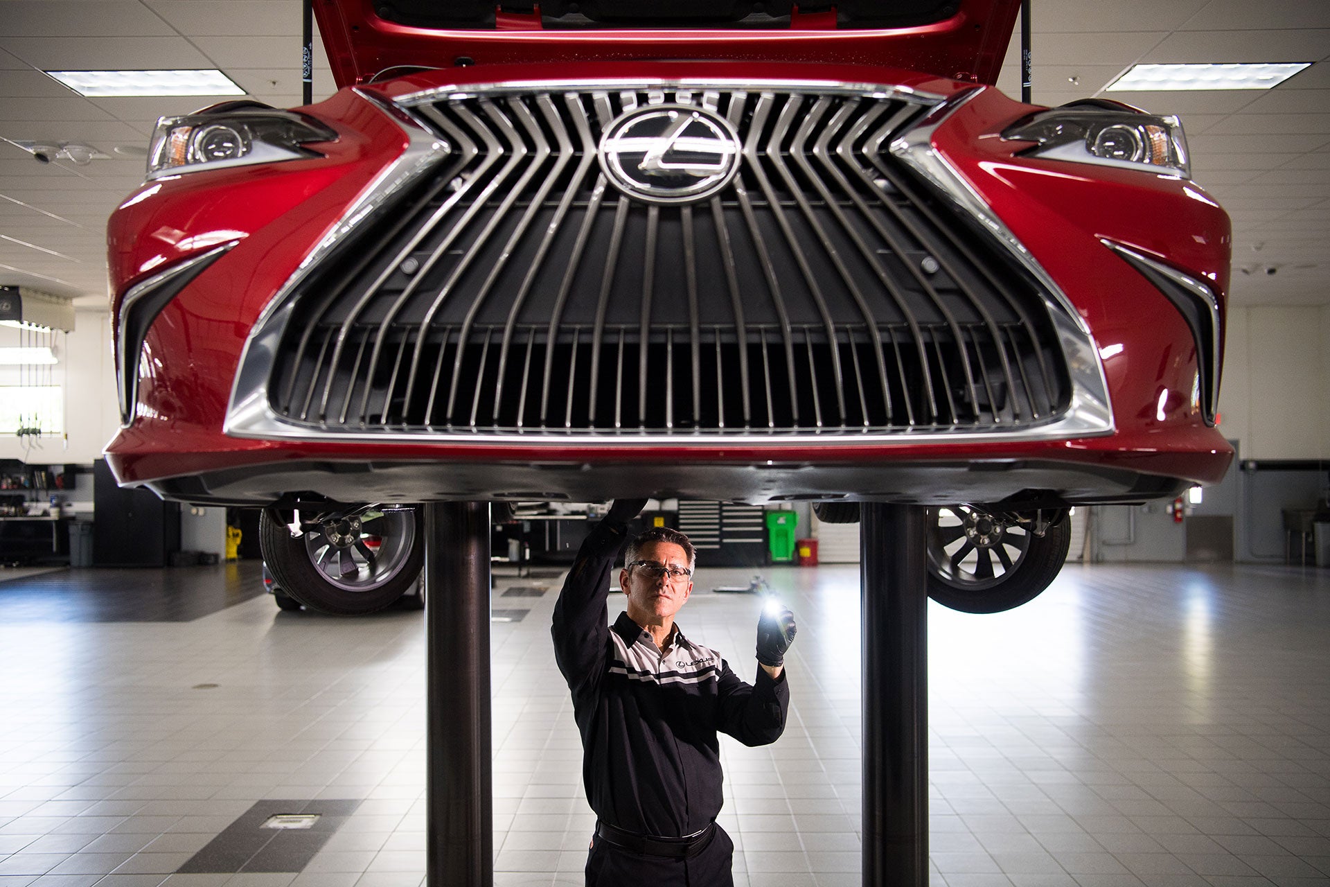 Lexus service tech fixing car